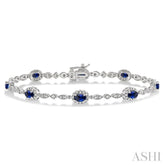 5x3 MM Oval Cut Sapphire and 1/20 Ctw Round Cut Diamond Bracelet in 14K White Gold